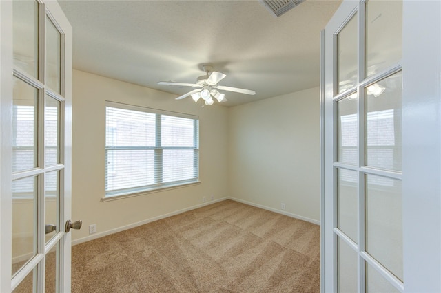 20218 Cypresswood Gln, Spring, TX 77373 - spare room featuring french doors, light carpet, and a ceiling fan