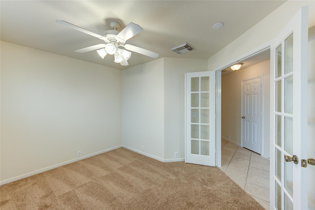 20218 Cypresswood Gln, Spring, TX 77373 - spare room featuring french doors, light colored carpet, a ceiling fan, and light tile patterned floors