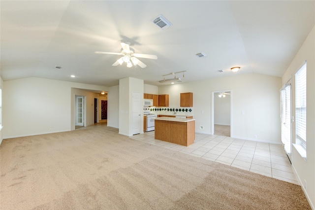 20218 Cypresswood Gln, Spring, TX 77373 - unfurnished living room with vaulted ceiling, ceiling fan, light colored carpet, light tile patterned flooring, and healthy amount of natural light