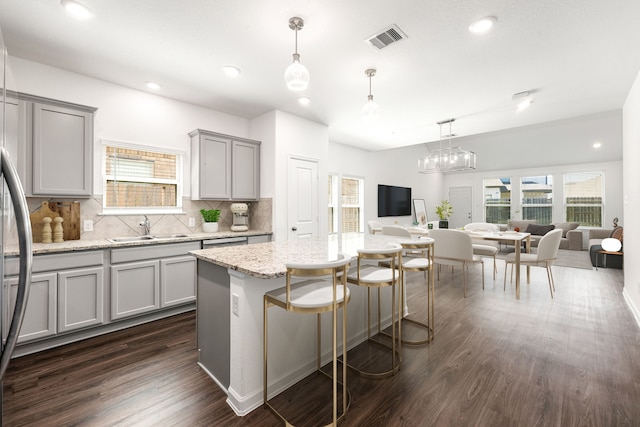 6223 Milbridge Creek Ln, Katy, TX 77493 - kitchen with open floor plan, gray cabinetry, decorative backsplash, dark wood finished floors, and plenty of natural light