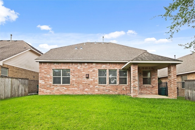 187 Black Swan Pl, The Woodlands, TX 77354 - rear view of property with roof with shingles, brick siding, a fenced backyard, and a patio