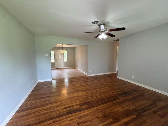 14410 Henry Rd, Houston, TX 77060 - spare room featuring arched walkways, a ceiling fan, and wood finished floors