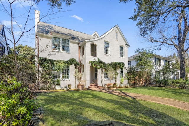 2248 Robinhood St, Houston, TX 77005 - view of front facade featuring brick siding, a front lawn, and a chimney