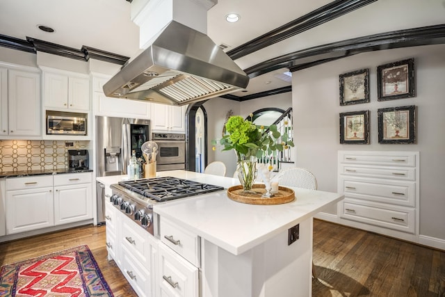 2248 Robinhood St, Houston, TX 77005 - kitchen with island exhaust hood, stainless steel appliances, ornamental molding, white cabinets, and dark wood-type flooring