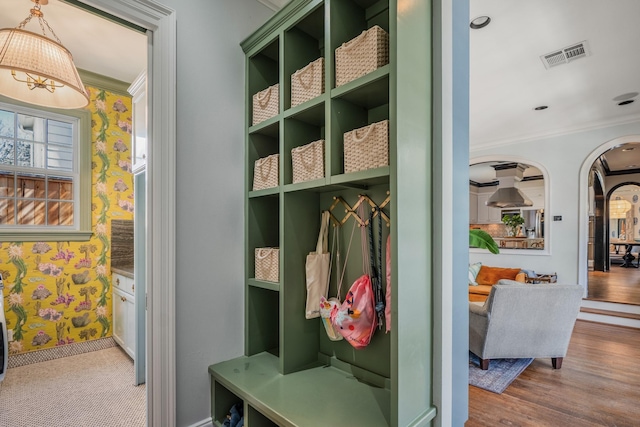 2248 Robinhood St, Houston, TX 77005 - mudroom with crown molding, arched walkways, wood finished floors, and wallpapered walls
