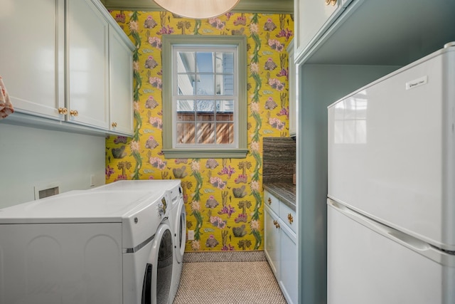 2248 Robinhood St, Houston, TX 77005 - laundry room with wallpapered walls, cabinet space, and washer and clothes dryer