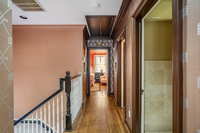 2248 Robinhood St, Houston, TX 77005 - corridor featuring attic access, an upstairs landing, ornamental molding, wood finished floors, and wallpapered walls