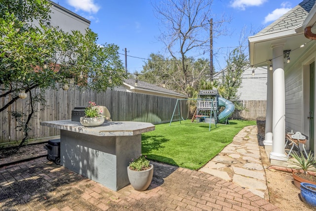 2248 Robinhood St, Houston, TX 77005 - fenced backyard featuring a playground and a patio