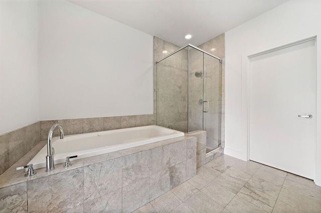 4707 Caroline St, Houston, TX 77004 - bathroom with a garden tub, a shower stall, and tile patterned flooring