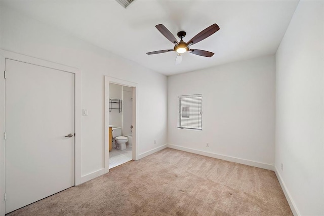 4707 Caroline St, Houston, TX 77004 - unfurnished bedroom with light carpet, connected bathroom, and ceiling fan