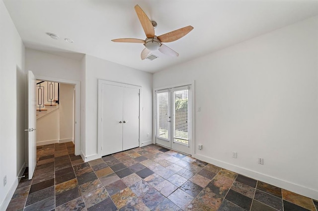 4707 Caroline St, Houston, TX 77004 - unfurnished bedroom with stone tile flooring, access to outside, ceiling fan, and a closet
