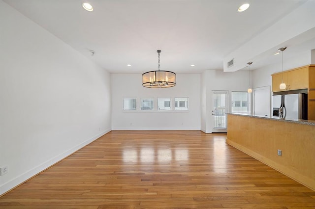 4707 Caroline St, Houston, TX 77004 - unfurnished living room featuring recessed lighting, a chandelier, and light wood-type flooring