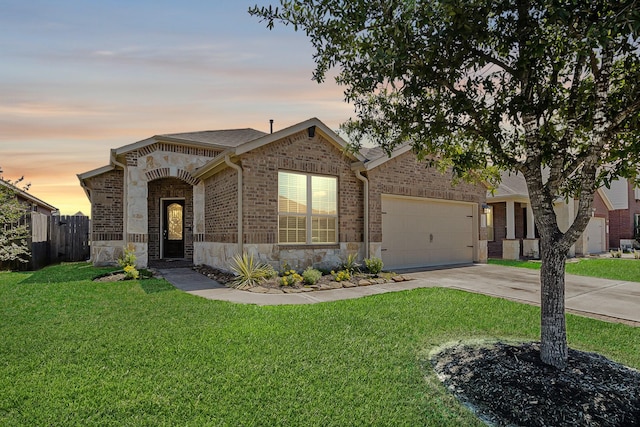 23719 Scotsman Dr, Katy, TX 77493 - view of front of house with stone siding, an attached garage, driveway, and brick siding