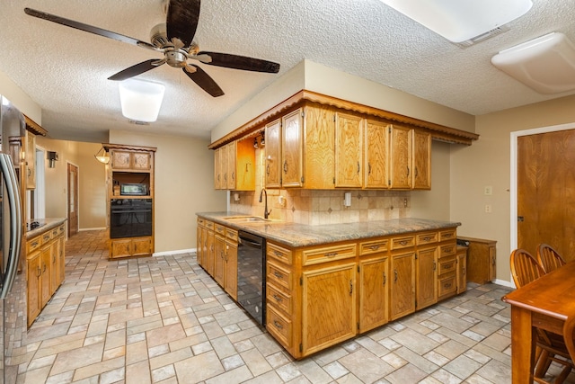 108 Laurel Valley Dr, West Columbia, TX 77486 - kitchen featuring black appliances, a ceiling fan, a textured ceiling, backsplash, and brown cabinetry