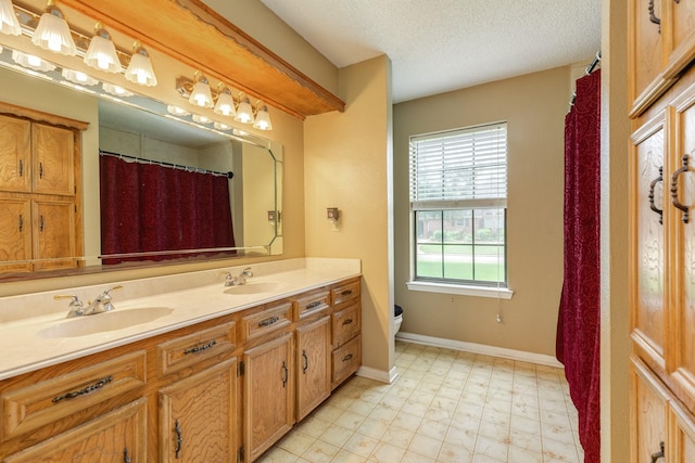 108 Laurel Valley Dr, West Columbia, TX 77486 - bathroom featuring double vanity, a textured ceiling, and tile patterned floors