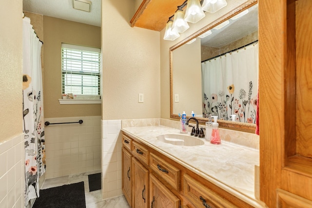 108 Laurel Valley Dr, West Columbia, TX 77486 - full bathroom with tile walls, vanity, and wainscoting