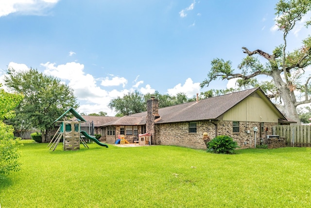 108 Laurel Valley Dr, West Columbia, TX 77486 - back of property with a playground, brick siding, a chimney, and a shingled roof