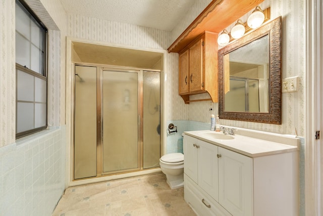 108 Laurel Valley Dr, West Columbia, TX 77486 - full bath featuring wallpapered walls, a shower stall, vanity, a wainscoted wall, and tile walls