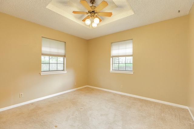 108 Laurel Valley Dr, West Columbia, TX 77486 - carpeted spare room with plenty of natural light, a textured ceiling, a tray ceiling, and ceiling fan