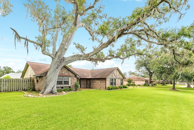 108 Laurel Valley Dr, West Columbia, TX 77486 - view of home's exterior featuring brick siding and roof with shingles