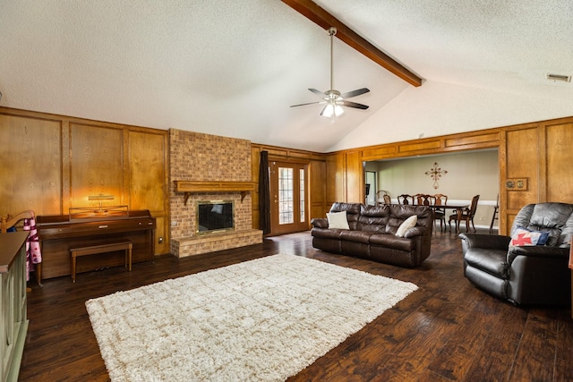 108 Laurel Valley Dr, West Columbia, TX 77486 - living room with dark wood-style floors, ceiling fan, a textured ceiling, wooden walls, and a fireplace