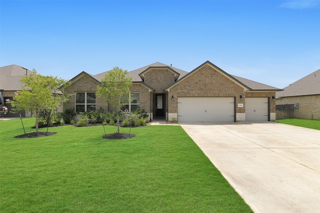 12806 Durham Creek Ln, Tomball, TX 77375 - ranch-style house featuring brick siding, an attached garage, concrete driveway, and a front lawn