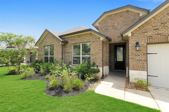 12806 Durham Creek Ln, Tomball, TX 77375 - doorway to property with brick siding, a yard, and a garage