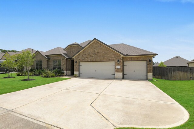 12806 Durham Creek Ln, Tomball, TX 77375 - view of front of house featuring brick siding, an attached garage, driveway, and roof with shingles