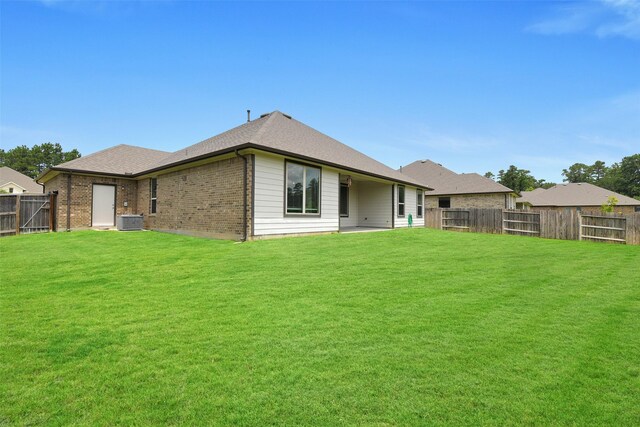 12806 Durham Creek Ln, Tomball, TX 77375 - back of property with a fenced backyard, brick siding, and a shingled roof