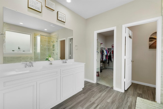 12806 Durham Creek Ln, Tomball, TX 77375 - bathroom with a stall shower, a spacious closet, wood finished floors, double vanity, and recessed lighting