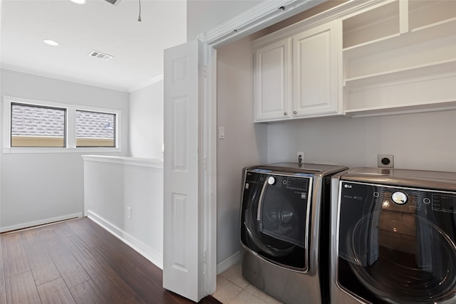 802 Malone St Unit A, Houston, TX 77007 - washroom featuring cabinet space, independent washer and dryer, ornamental molding, wood finished floors, and recessed lighting