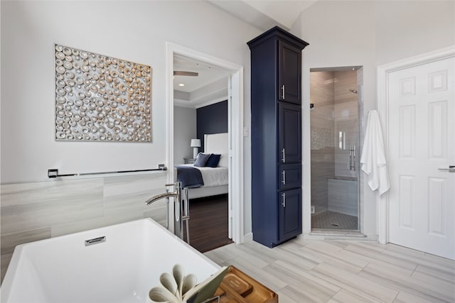 802 Malone St Unit A, Houston, TX 77007 - ensuite bathroom featuring a freestanding tub, a stall shower, and wood tiled floors