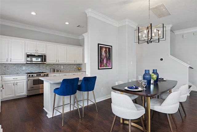 802 Malone St Unit A, Houston, TX 77007 - kitchen featuring stainless steel appliances, backsplash, dark wood-type flooring, white cabinetry, and a breakfast bar area