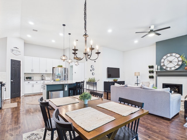 6003 Rivergrove Bend Dr, Humble, TX 77346 - dining room featuring ceiling fan, dark wood finished floors, recessed lighting, a chandelier, and a fireplace