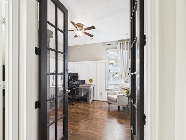 6003 Rivergrove Bend Dr, Humble, TX 77346 - home office with ceiling fan, dark wood-style flooring, a wainscoted wall, and a decorative wall