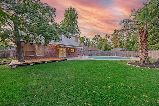 3307 La Seine Ln, Spring, TX 77388 - yard at dusk with a fenced backyard and a deck