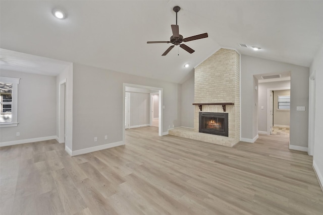 2915 Katy Hockley Rd, Katy, TX 77493 - unfurnished living room featuring ceiling fan, a brick fireplace, light wood-type flooring, and lofted ceiling