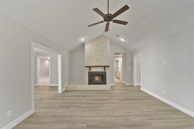 2915 Katy Hockley Rd, Katy, TX 77493 - unfurnished living room featuring a ceiling fan, a fireplace, light wood-type flooring, and vaulted ceiling