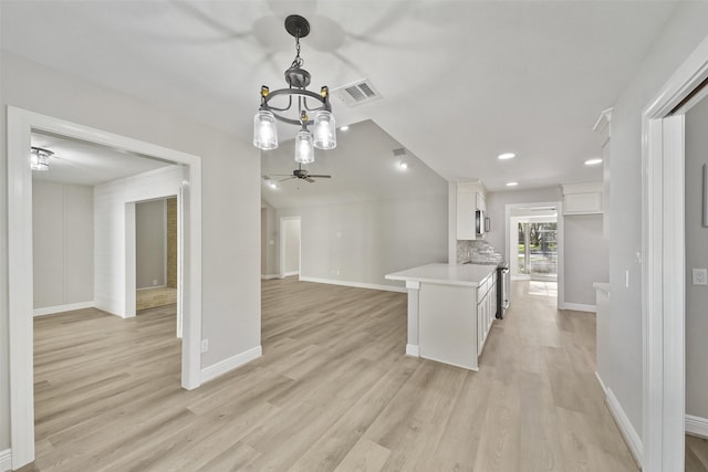 2915 Katy Hockley Rd, Katy, TX 77493 - kitchen with white cabinetry, a chandelier, a ceiling fan, light countertops, and light wood-style floors