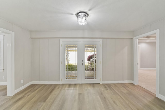 2915 Katy Hockley Rd, Katy, TX 77493 - unfurnished dining area with a decorative wall, french doors, and wood finished floors