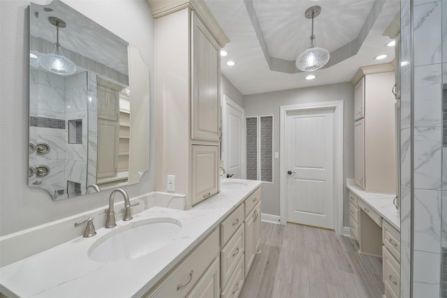 2915 Katy Hockley Rd, Katy, TX 77493 - bathroom featuring double vanity, recessed lighting, wood finished floors, and a tray ceiling