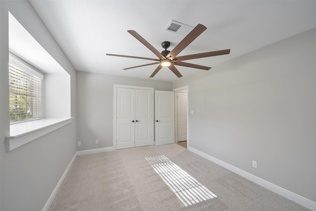 2915 Katy Hockley Rd, Katy, TX 77493 - unfurnished bedroom with a closet, light colored carpet, and a ceiling fan