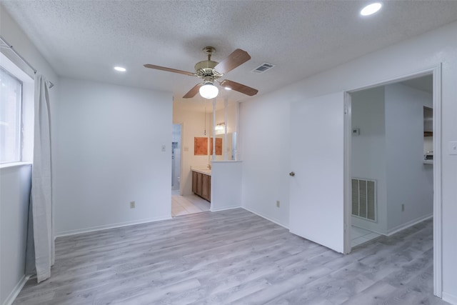 5026 Algernon Dr, Spring, TX 77373 - empty room featuring a ceiling fan, light wood-style floors, a textured ceiling, and recessed lighting