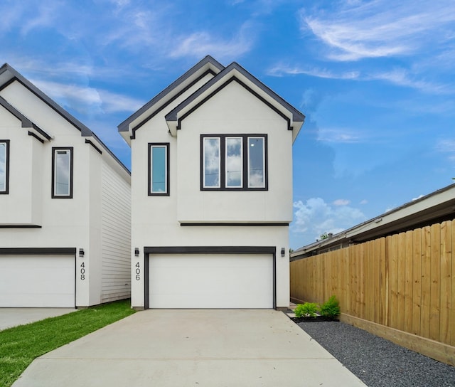 406 E 33rd St, Houston, TX 77018 - view of front facade featuring driveway, a garage, and stucco siding