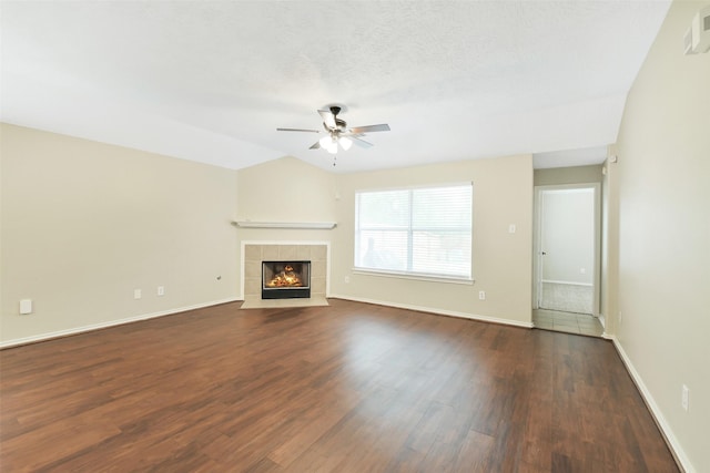 6611 Atasca Creek Dr, Humble, TX 77346 - unfurnished living room featuring ceiling fan, dark wood-type flooring, and a fireplace