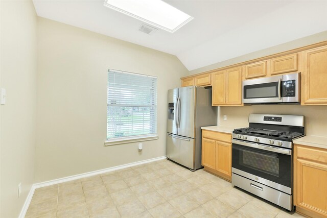 6611 Atasca Creek Dr, Humble, TX 77346 - kitchen featuring appliances with stainless steel finishes, vaulted ceiling, light countertops, and light brown cabinets