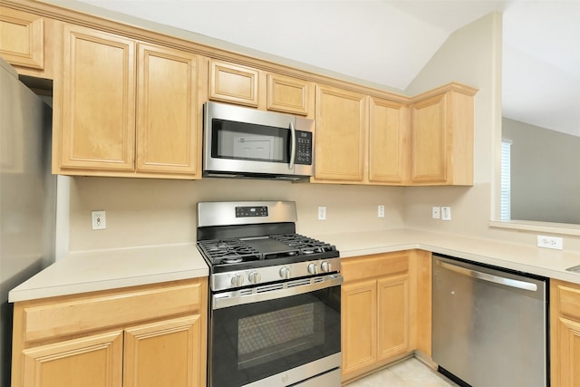 6611 Atasca Creek Dr, Humble, TX 77346 - kitchen with stainless steel appliances, light brown cabinetry, lofted ceiling, and light countertops