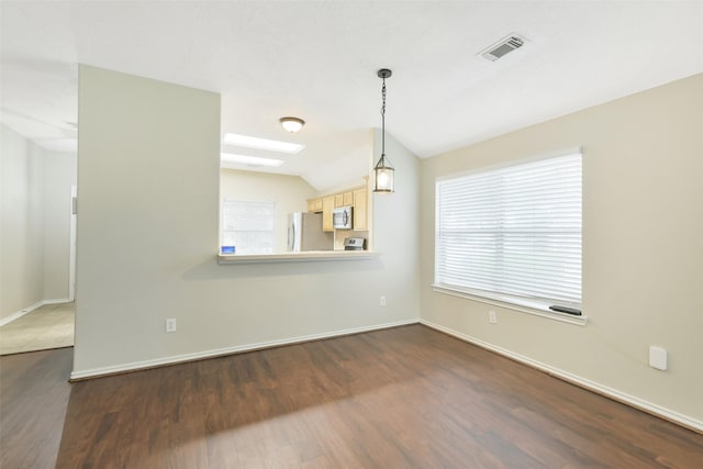 6611 Atasca Creek Dr, Humble, TX 77346 - empty room with a skylight, dark wood-style floors, and vaulted ceiling