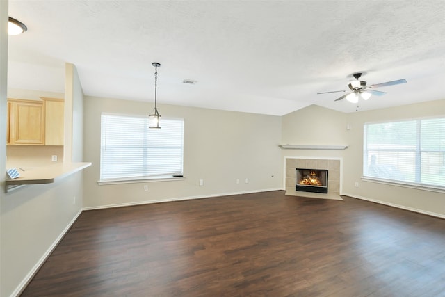 6611 Atasca Creek Dr, Humble, TX 77346 - unfurnished living room with dark wood-style floors, healthy amount of natural light, ceiling fan, and a textured ceiling