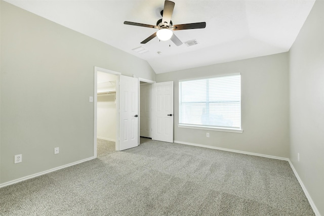 6611 Atasca Creek Dr, Humble, TX 77346 - unfurnished bedroom with carpet floors, a spacious closet, vaulted ceiling, and a ceiling fan